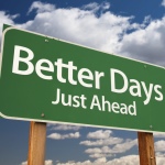 Better Days, Just Ahead Green Road Sign with Copy Room Over The Dramatic Clouds and Sky.