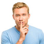 sexy man with finger on lips keeping a secret